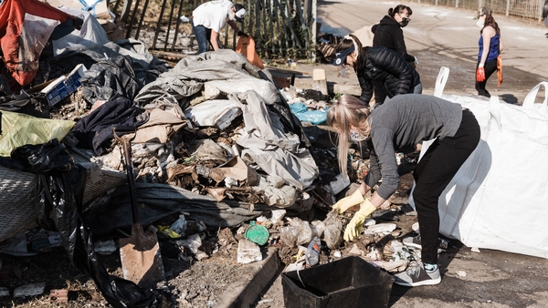 Locals clean-up debris left by looting and rioting on Queen Nandi Drive in Durban
