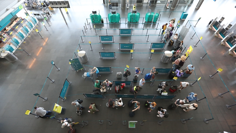 Passengers queuing at check-in desks to show their Covid vaccine certs at Dublin Airport