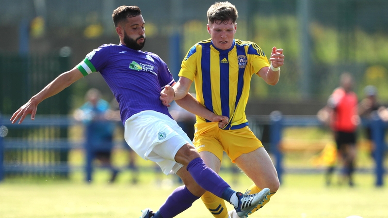 David Webster of Finn Harps challenges Conor Coughlan of Fairview Rangers