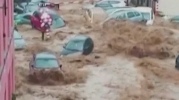 Dozens of cars were swept down the street
