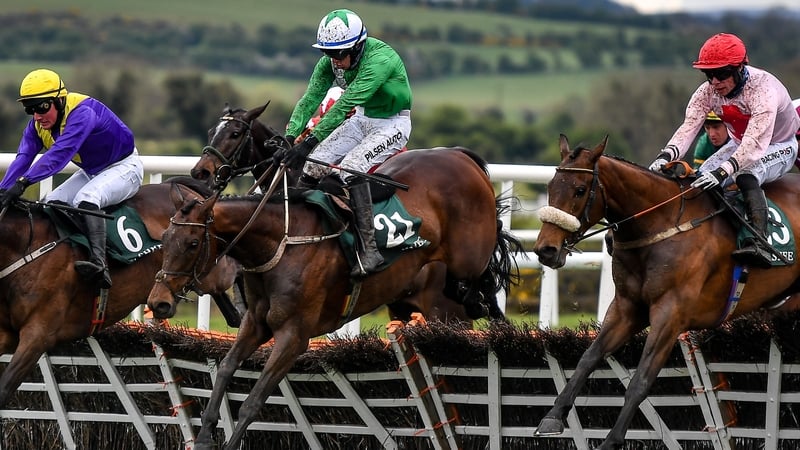 Conor McNamara and Jazzaway (centre) jump the last