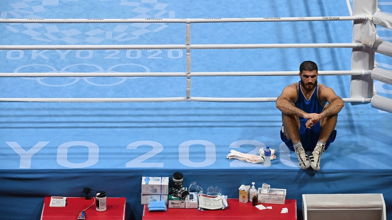 Mourad Aliev sits on the edge of the ring