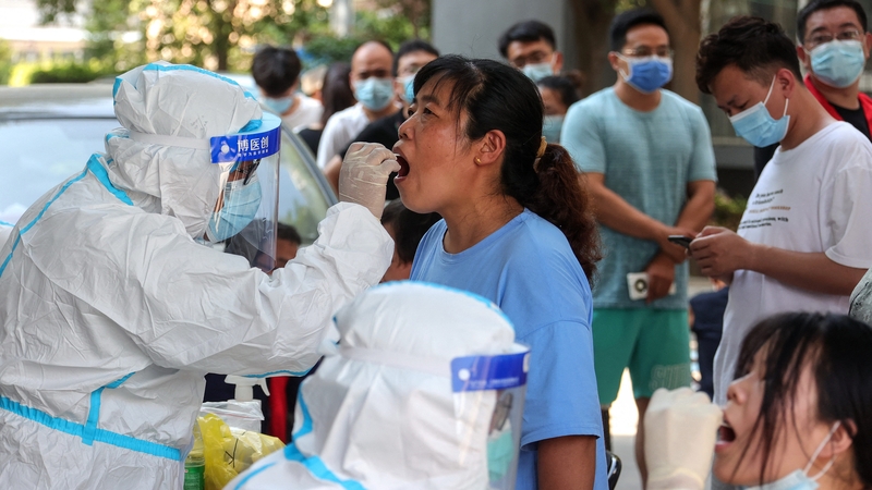 A woman receives a Covid test in Zhengzhou, in China's central Henan province