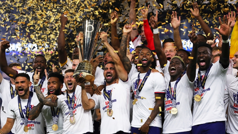 US midfielder Sebastian Lletget lifts the trophy