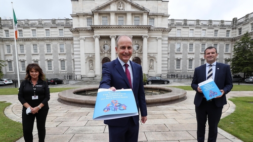 Taoiseach Micheál Martin (C), Home Instead's COO Shane Jennings and caregiver Ger Baldrick at the jobs announcement