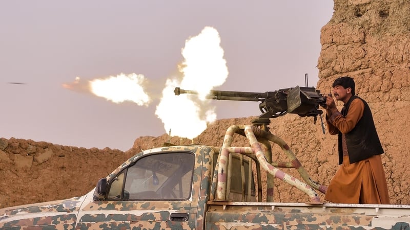 An anti-Taliban militia fighter fires a heavy machine gun in Mukhtar, on the outskirts of Lashkar Gah (File pic)