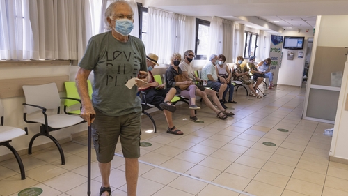 Elderly residents receive their third dose of the Pfizer-BioNTech vaccine in Tel Aviv, Israel