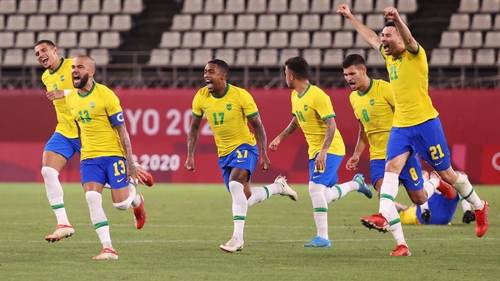 Dani Alves and his team-mates celebrate the penalty shootout victory over Mexico in the semi-final