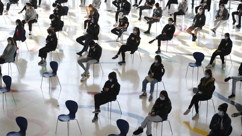 Students wait for their turn to receive their first dose of the Pfizer Covid vaccine in Sydney