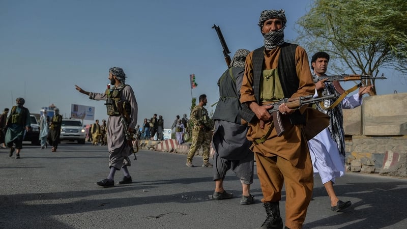 Afghan security personnel stand guard in Enjil district of Herat province