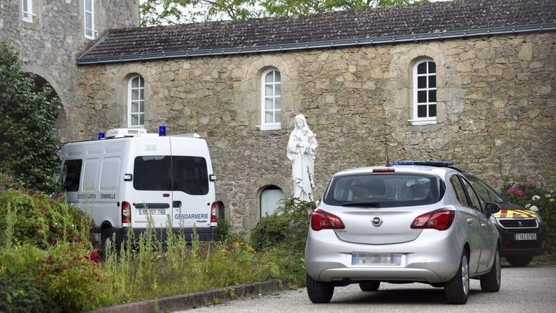 French gendarmerie vehicles are parked where a French catholic priest was murdered in Saint-Laurent-sur-Sevres