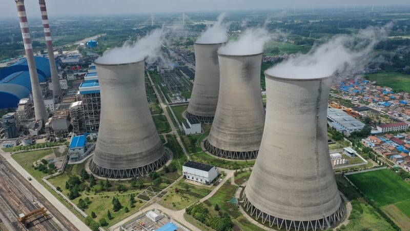 Steam billows out of the cooling towers of a coal-fired power plant in Huai'an in east China's Jiangsu province