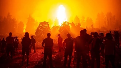 Fact, not fiction: people watching as wildfires rage on the Greek island of Evia. Photo: Angelos Tzortzinis/Getty Images