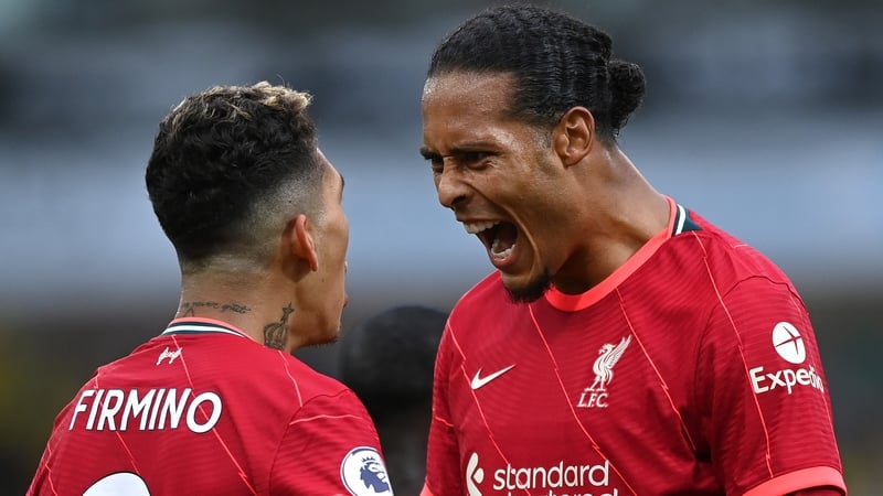 Van Dijk celebrates with Roberto Firmino after the second Liverpool goal at Carrow Road