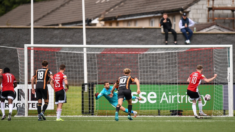 Jamie McGonigle slots home the winning penalty