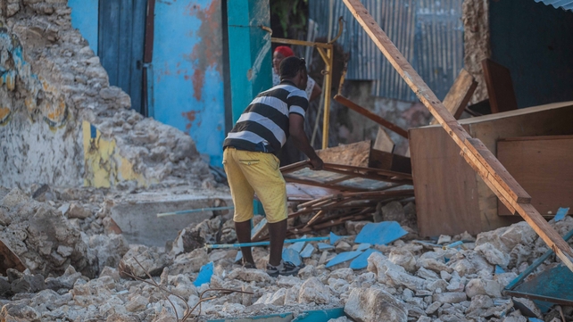 A man recovers what he can after a 7.2-magnitude earthquake struck Haiti