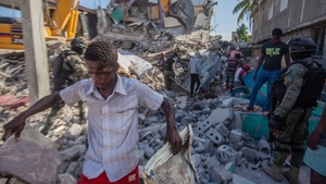 Haitians begin the work of recovering what materials can be after a 7.2-magnitude earthquake