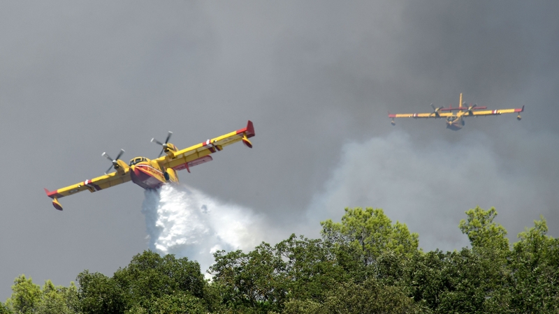 Canadair CL 415 aircrafts drop water to extinguish a forest fire in Gonfaron, France, today