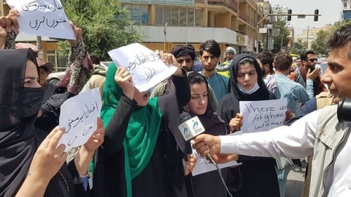 Afghan women, holding placards, gather to demand the protection of women's rights in front of the Presidential Palace in Kabul
