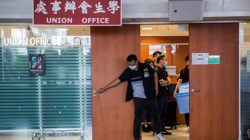 Police seen at the student union's offices in July