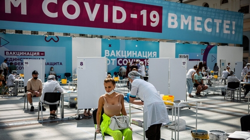 A woman receives a dose of Russia's Sputnik V Covid-19 vaccine at a vaccination centre at Gostiny Dvor in Moscow