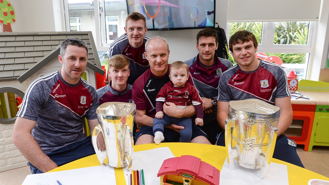 Colm Callanan (L) and Joe Canning (back) with Galway's trophy haul at Crumlin Children's hospital in 2017