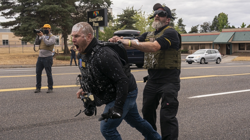 Members of the Proud Boys react to an attack by counter-protesters in Portland