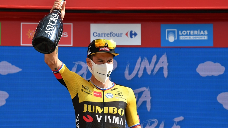 Primoz Roglic celebrates on the podium