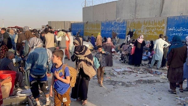 People who want to flee continue to wait around Kabul airport
