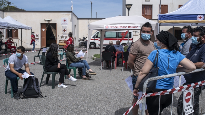 People wait from the anamnesis point to receive their vaccine shots during the mass vaccination