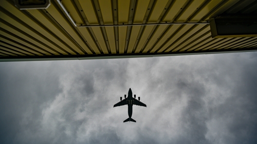 A plane flies over temporary camp for refugees from Afghanistan at the US Army's Rhine Ordnance Barracks