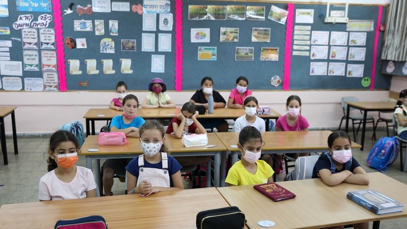 Children attend a class at an elementary school on the first day of school in Jerusalem