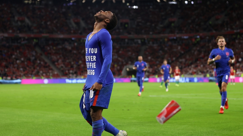 A cup is hurled towards England's Raheem Sterling as he celebrates scoring the first goal of the night