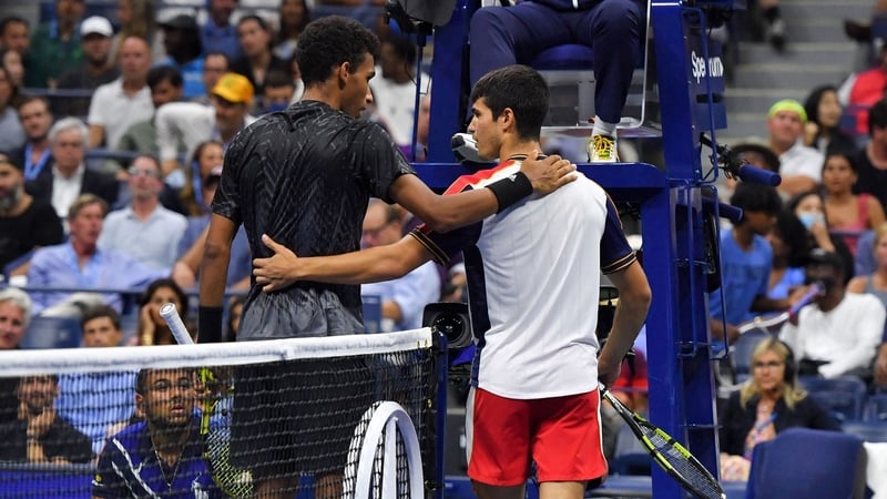 Canada's Felix Auger-Aliassime (L) commiserates with Spain's Carlos Alcaraz