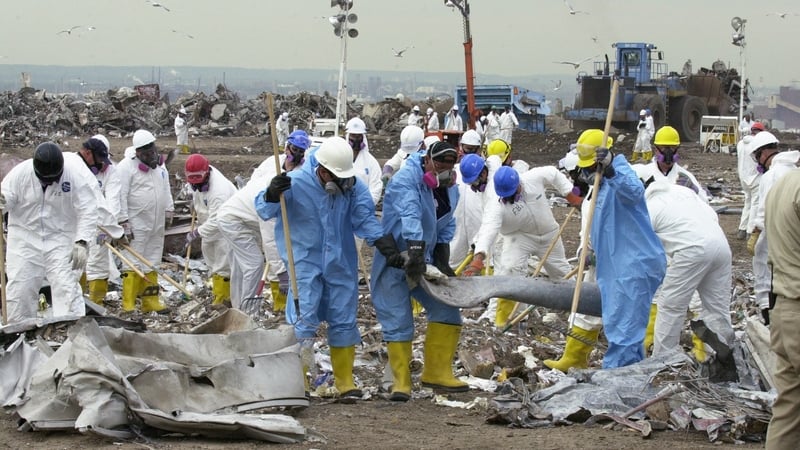 Workers pick through debris at the Fresh Kills landfill on 18 September 2001
