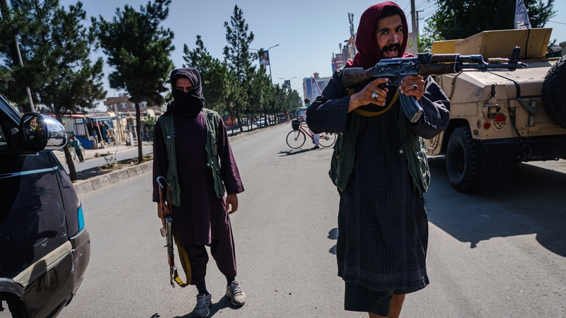 Taliban fighters try to stop the advance of protesters marching through the Dashti-E-Barchi neighbourhood
