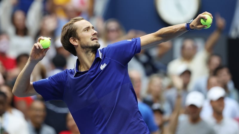 Medvedev throws a tennis ball to fans after clinching victory