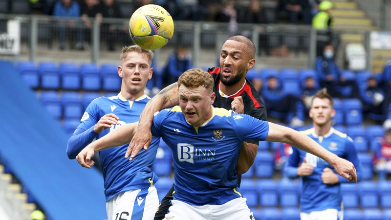 St Johnstone's James Brown (left) holds off Rangers' Kemar Roofe
