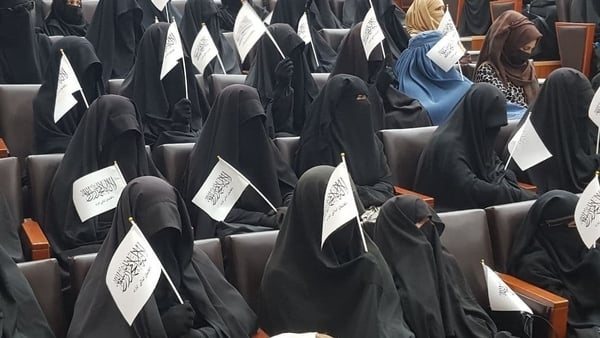 Women students show their support for the Taliban at a Kabul university