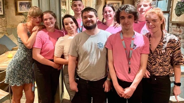 Taylor Swift (left) with the staff of the Tipsy Bird in Belfast
