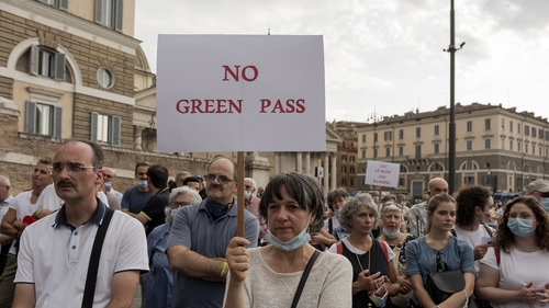 A demonstrator holds up a banner during a demonstration against the 'Green Pass' last weekend