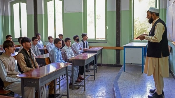Boys attend their class at a school in Kabul today