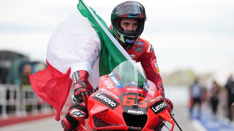 Francesco Bagnaia enjoys a lap of honour at the San Marino track