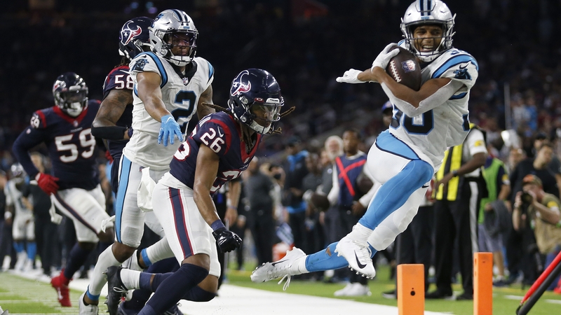 Chuba Hubbard (30) of the Carolina Panthers gets pushed out of bounds by Vernon Hargreaves III (26) of the Houston Texans