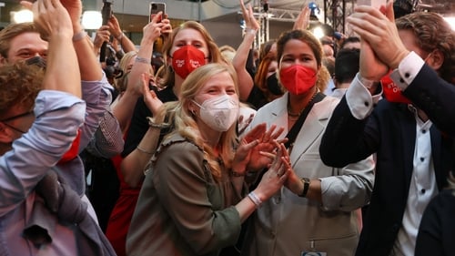 Members of the German Social Democrats (SPD) celebrate initial results at SPD headquarters in Berlin