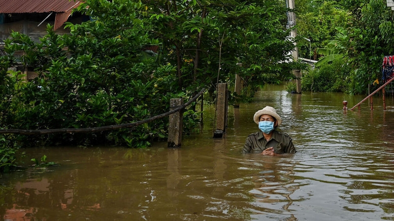 A resident wades through a flooded neighbourhood in the central province of Ayutthaya