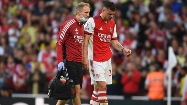 Arsenal physio Jordan Reece helps the injured Granit Xhaka off the pitch