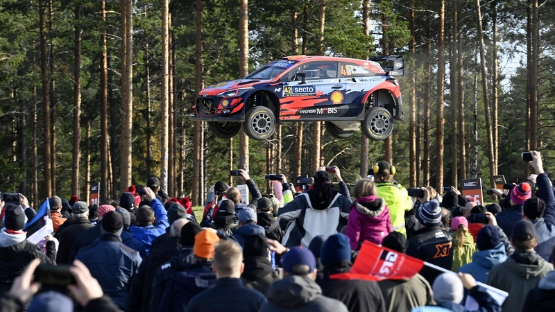 Spectators watch as the Hyundai of Irish driver Craig Breen and his Irish co-driver Paul Nagle soar through the air in Finland