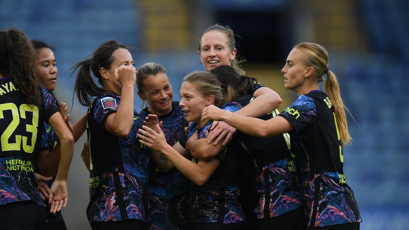 Spurs player celebrate with Angela Addison after her second goal