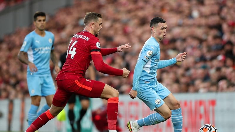 Phil Foden in action against Jordan Henderson at Anfield